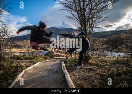 couple jumping i the forest with beautiful landscape Stock Photo