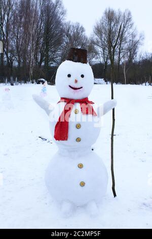 Snowman cheerful in the snow. New Year Attribute. Christmas symbol Stock Photo