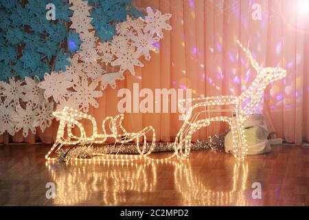 Fairy deer made from garland with sleds. Christmas decorations in festive hall Stock Photo