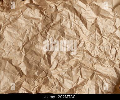 crumpled brown parchment baking paper, full frame, close up Stock Photo