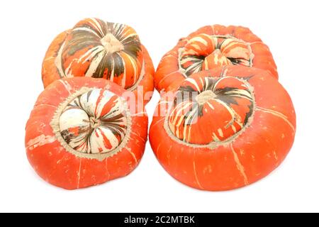 Four large Turks Turban ornamental gourds with orange caps and striped centres, on a white background Stock Photo