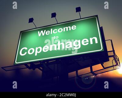 Welcome to Copenhagen - Green Billboard on the Rising Sun Background. Stock Photo