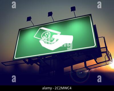 Icon of Money in the Hand on Green Billboard at Sunrise. Stock Photo