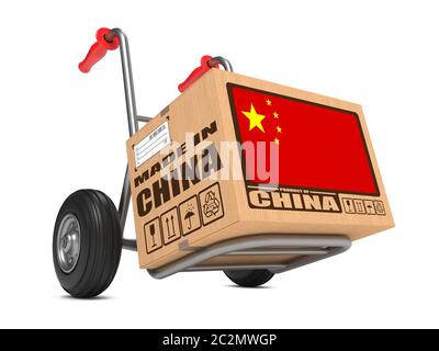 Cardboard Box with Flag of China and Made in China Slogan on Hand Truck White Background. Free Shipping Concept. Stock Photo