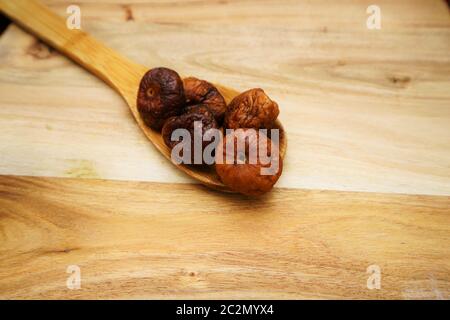 Some dried figs on a wooden board Stock Photo