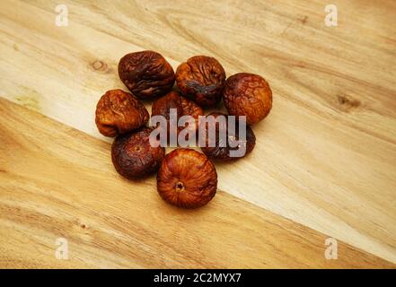 Some dried figs on a wooden board Stock Photo