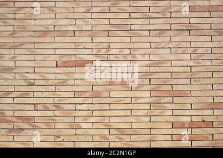 Background from a wall of beige clinker bricks Stock Photo