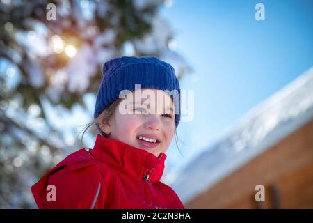 Portrait of a cute little girl having fun outdoors, cheerful child enjoying sunny winter day, happy winter holidays Stock Photo