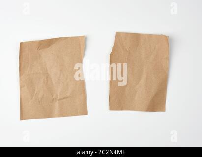 crumpled blank sheet of brown wrapping kraft paper with torn edges, vintage texture for the designer.  Torn paper sheet Stock Photo