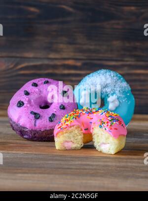 Assortment of donuts on wooden background Stock Photo