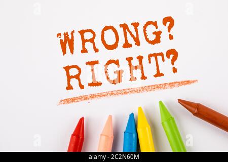 WRONG or RIGHT. Ethic concept. Text on a white page. Colored pastels Stock Photo