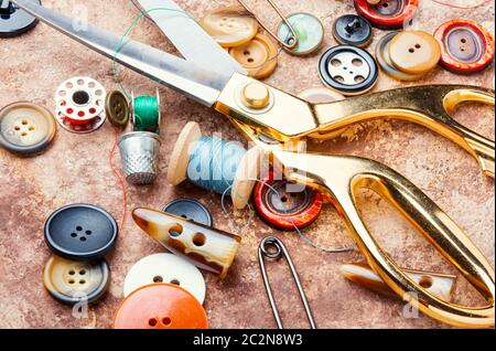 Sewing tools, scissors, many buttons and threads Stock Photo
