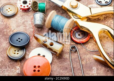 Sewing tools, scissors, many buttons and threads Stock Photo