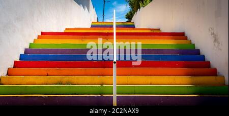 Perspective view of colorful stairs painted with the colors of the rainbow Stock Photo