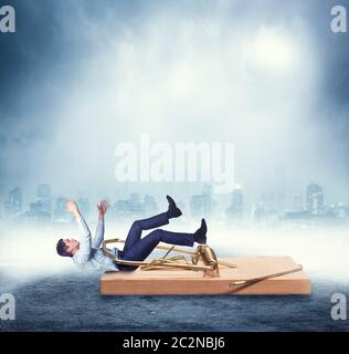 Young businessman catched in the mousetrap over city background Stock Photo