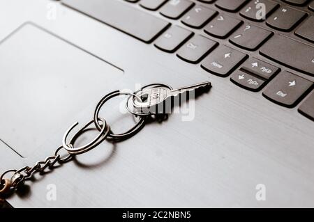 Close up of Still life of Key Ring on laptop computer keyboard. Conceptual image shown as network security key. Cyber Security, protection and privacy Stock Photo