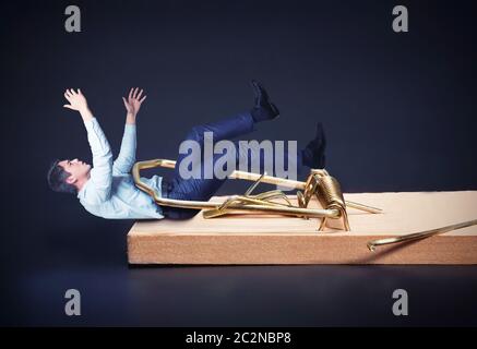 Young businessman catched in the mousetrap Stock Photo
