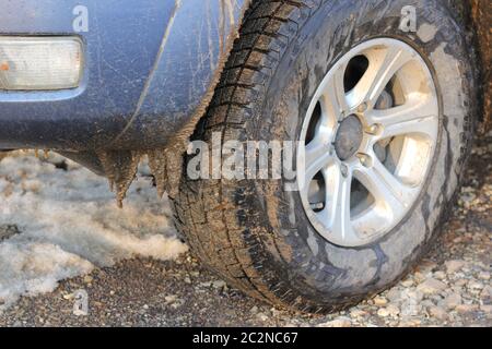 Car tires dirt road in winter snow and ice Stock Photo