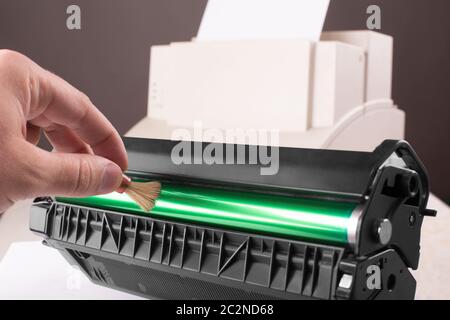 Technician hand cleaning printer toner cartridge Stock Photo