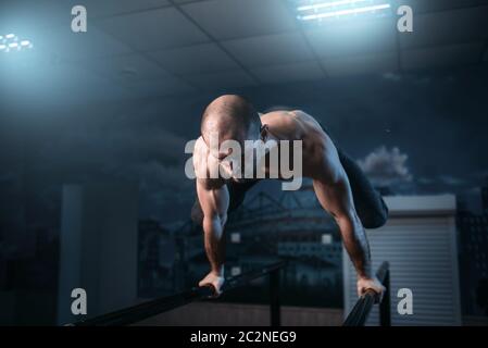 man makes exercises with bar in exercise room Stock Photo - Alamy