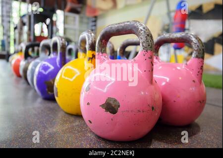 colorful kettlebells in a row in a gym Stock Photo