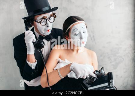 Pantomime theater actor and actress performing. Mime artists with white makeup masks on faces Stock Photo