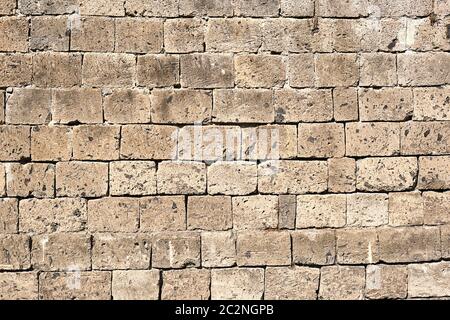 Background from a beige natural stone wall Stock Photo