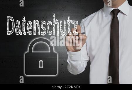 Datenschutz (in german Privacy Policy) is written by businessman on screen. Stock Photo