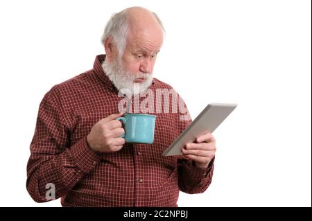 Funny shocked senior man with cup using tablet computer isolated on white Stock Photo