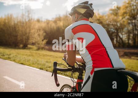 Male bycyclist in sportswear, cycling on bike path. Sportsman rides on bicycle Stock Photo