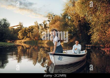 A Young Couple is Posing for a Photo on the Bow of the Yacht while Enjoying  a View and a Ride on the Sea. Summer, Sea, Vacation, Stock Photo - Image of