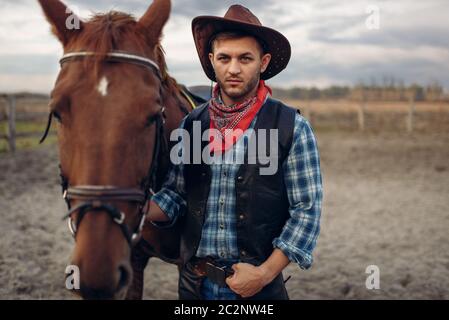Young Men In Cowboy Outfits Posing For The Camera High-Res Stock Photo -  Getty Images