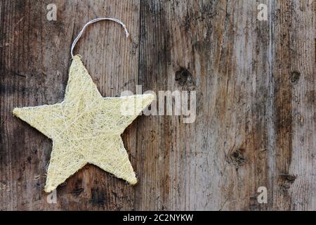 A golden Christmas star on a wooden background Stock Photo