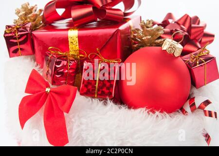 Cute christmas present and decorative tree ball on white fur carpet Stock Photo
