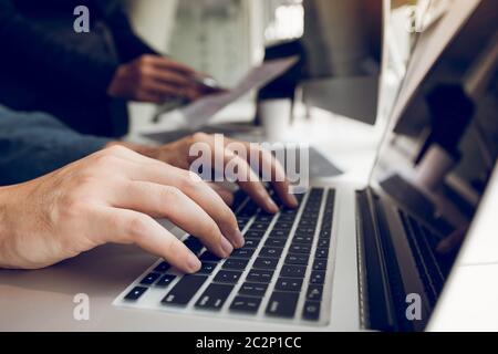 Two partnerships developing programming and coding technologies working on laptop and analyzing together. Stock Photo