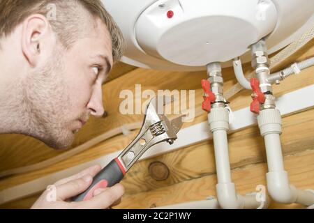 Plumber at work. Servicing gas boiler Stock Photo