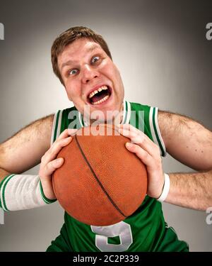 Portrait of bizarre basketball player with ball Stock Photo