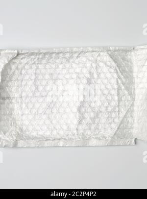 fragment of a transparent film with air for the transportation of parcels is glued on white polyethylene, inside of the envelope Stock Photo