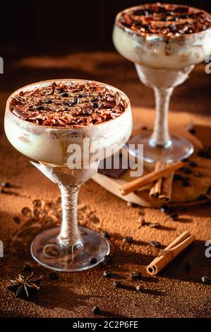 italian dessert tiramisu in an elegant cocktail glass, the concept of sweet life, luxury food Stock Photo