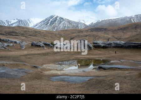 Rock formations and reflections at Kura Tawhiti Castle Hill Conservation Area, Canterbury, New Zealand Stock Photo