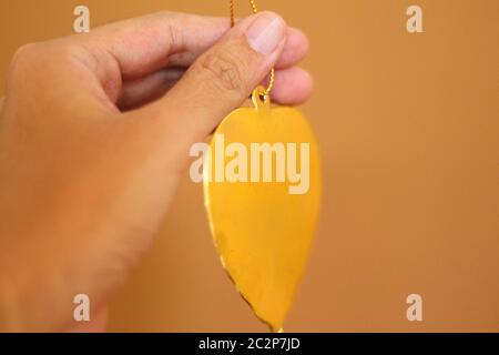 Golden leaf thai religious offering called wai phra in Buddhist religion Stock Photo
