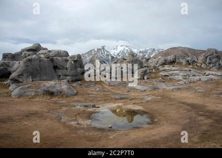 Rock formations and reflections at Kura Tawhiti Castle Hill Conservation Area, Canterbury, New Zealand Stock Photo