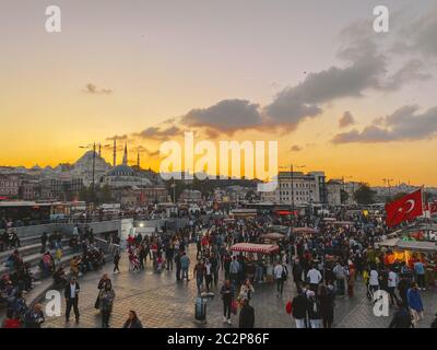 October 27, 2019. Eminonu square by sunset, Istanbul, in Turkey. People rest and socialize in a square near Galata Bridge, shopp Stock Photo