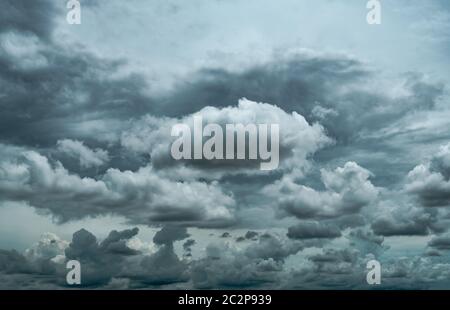 Dark dramatic sky and clouds. Background for death and sad concept. Gray sky and fluffy white clouds. Thunder and storm sky. Sad and moody sky. Nature Stock Photo