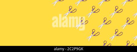 Scissors pattern on a yellow background. Office supplies layout. Stock Photo