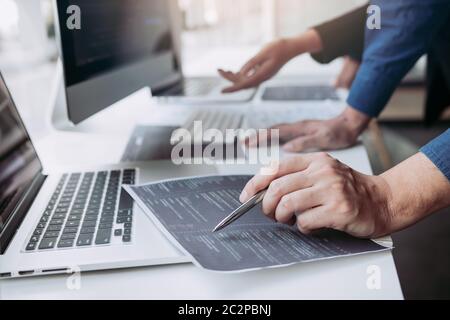 Professional development programmer cooperating meeting programming website working a software in office room. Stock Photo