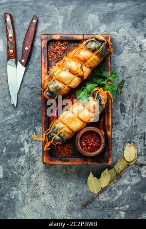 Hot smoked mackerel roll on kitchen board.Delicious smoked fish.Seafood Stock Photo