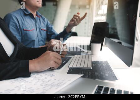 Two asian team working development of programming and encryption technology website design programmers on desk in office. Stock Photo