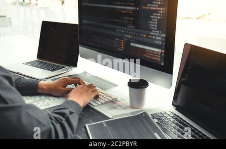 Asian man working code program developer computer web development working design software on desk in office. Stock Photo