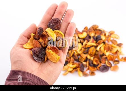 Mix of dried bits of  fruits on the hand Stock Photo